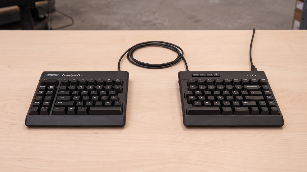 Kinesis Freestyle Pro split mechanical keyboard for programmers showing its adjustable separation cable.