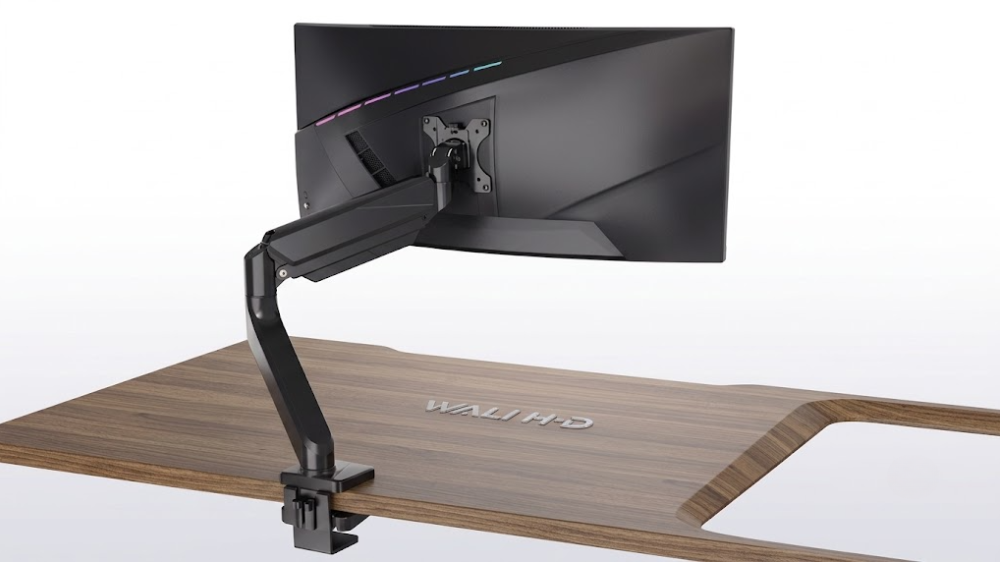 WALI budget gas spring monitor arm elevating a 34-inch ultrawide screen over a clean desk setup.